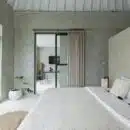 white bed near glass sliding door