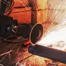 person grinding pipe steel wool photography