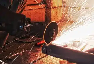 person grinding pipe steel wool photography