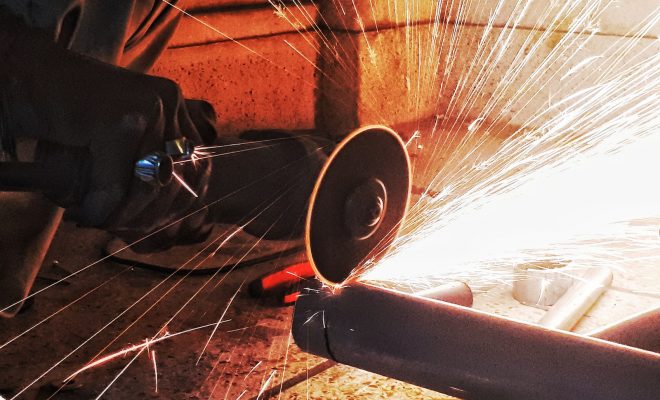 person grinding pipe steel wool photography