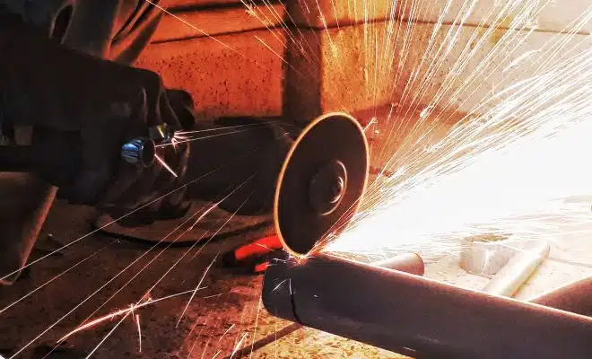 person grinding pipe steel wool photography