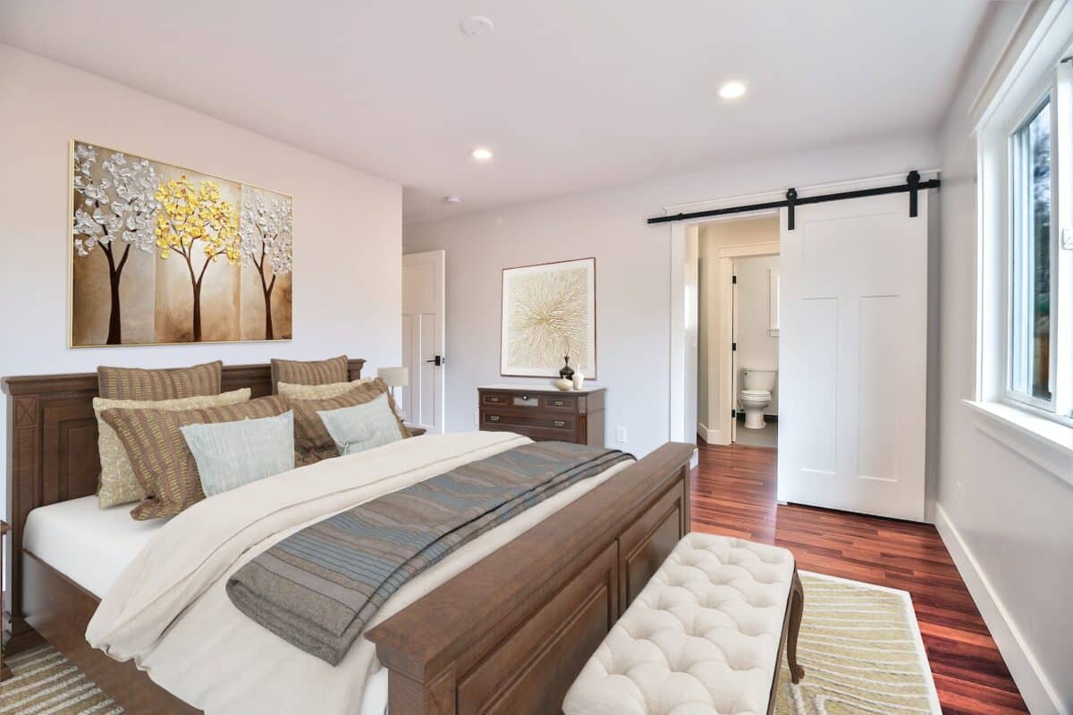 brown wooden bed frame with white and gray bed linen